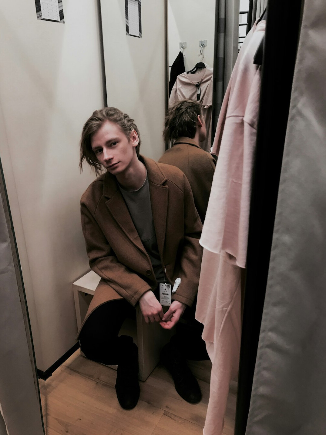 woman trying on coat in store